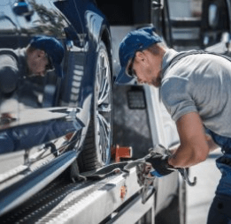 tow truck driver securing loaded car for safe delivery e1721202374220 1